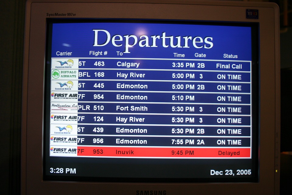 Airport departure screen displaying a delayed flight