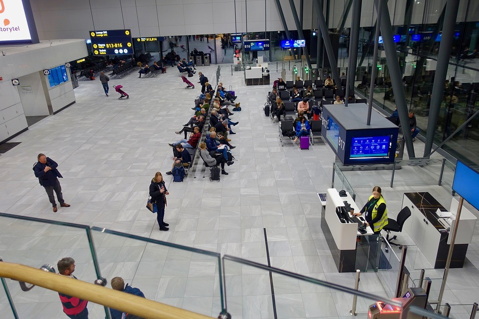 Passengers seated together near airport boarding gates