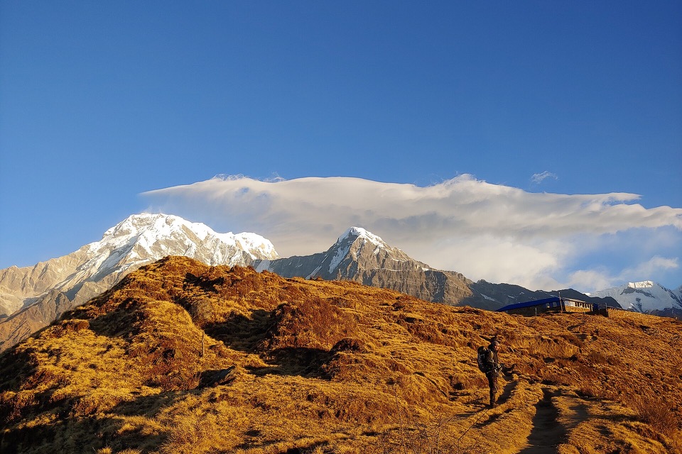 Golden morning light over Himalayan peaks from Badal Danda
